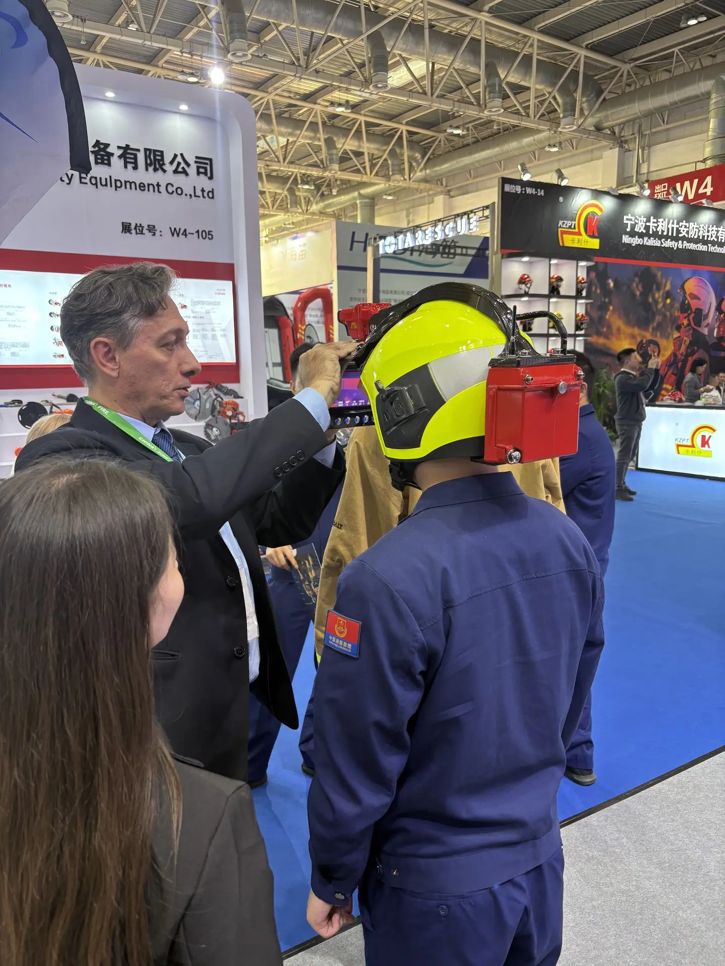 iFalconHM at China Fire 2025 A person trying on iFalconHM Helmet-Mounted Thermal Camera system